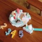 Complete wooden birthday cake Montessori playset showing all decorative elements and accessories