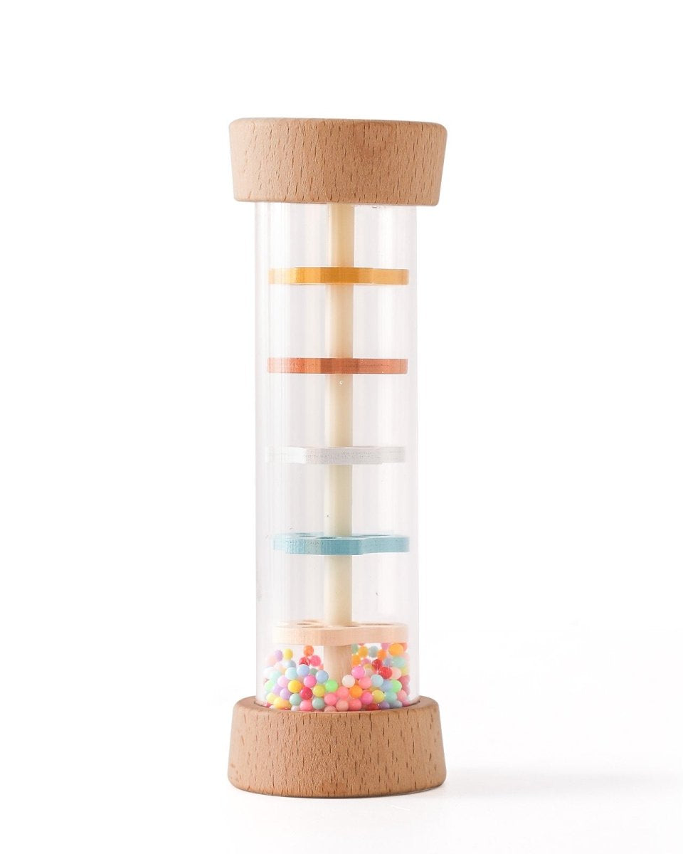 Close-up of Montessori rain sound toy showing pastel colored internal discs and rainbow beads