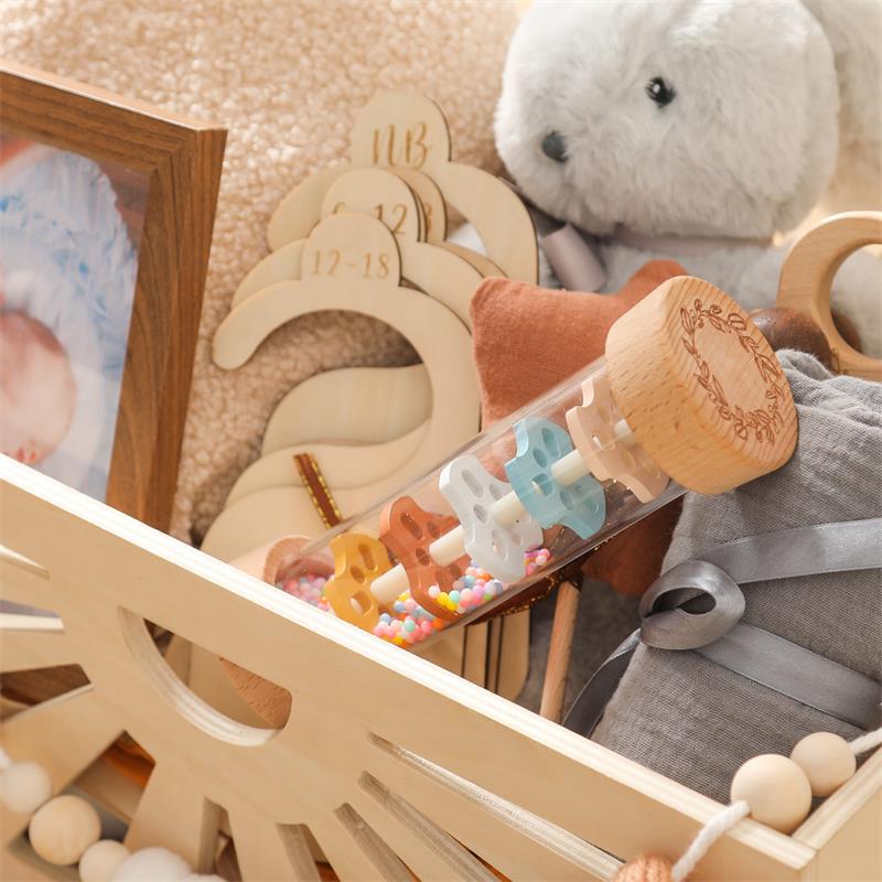 Natural beechwood end cap detail of Montessori rain sound toy featuring engraved leaf pattern