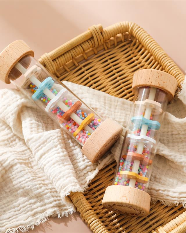 Pair of wooden rain sound cylinders demonstrating multi-sensory Montessori play options