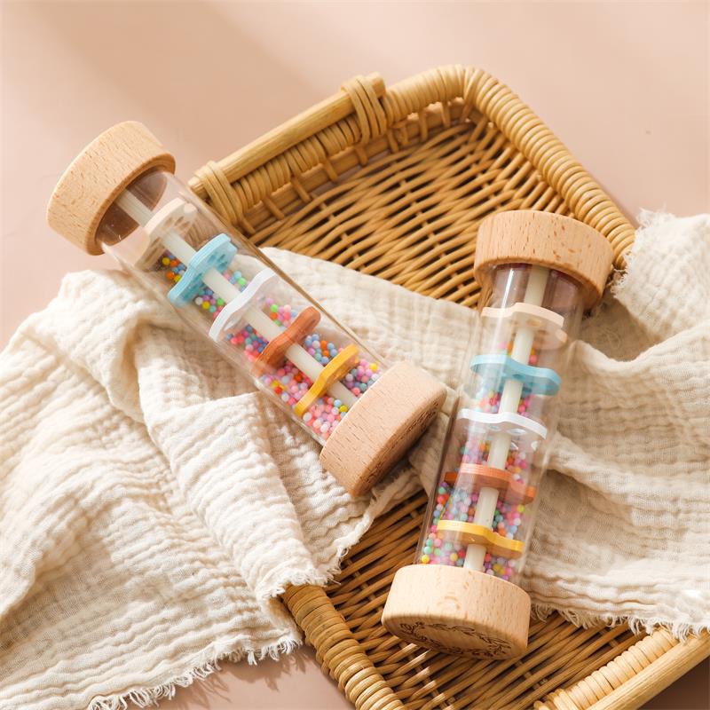 Pair of wooden rain sound cylinders demonstrating multi-sensory Montessori play options