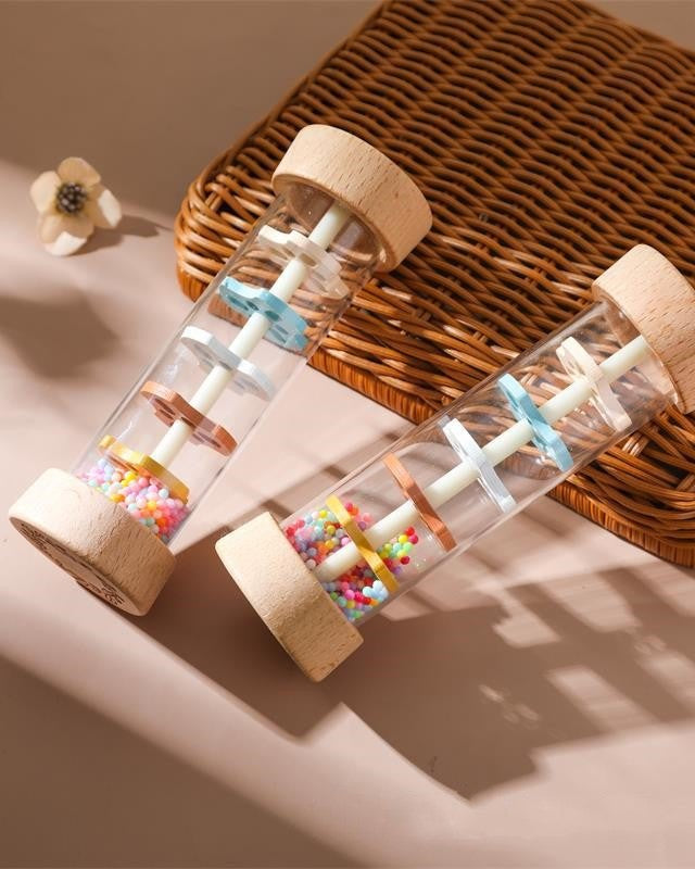 Transparent center of wooden rain sound toy showcasing colorful beads for visual tracking