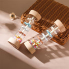 Transparent center of wooden rain sound toy showcasing colorful beads for visual tracking