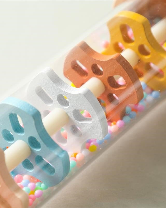 Montessori wooden rain sound cylinder displayed in playroom setting demonstrating sensory play value