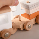 Complete Montessori wooden train set featuring engine and three unique cargo cars for developmental play