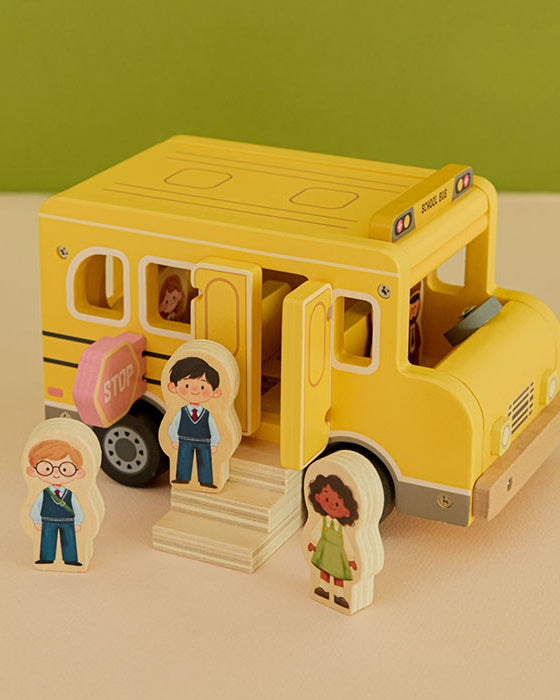 Fiesta wooden school bus playset with five diverse character figures and stop sign on neutral background