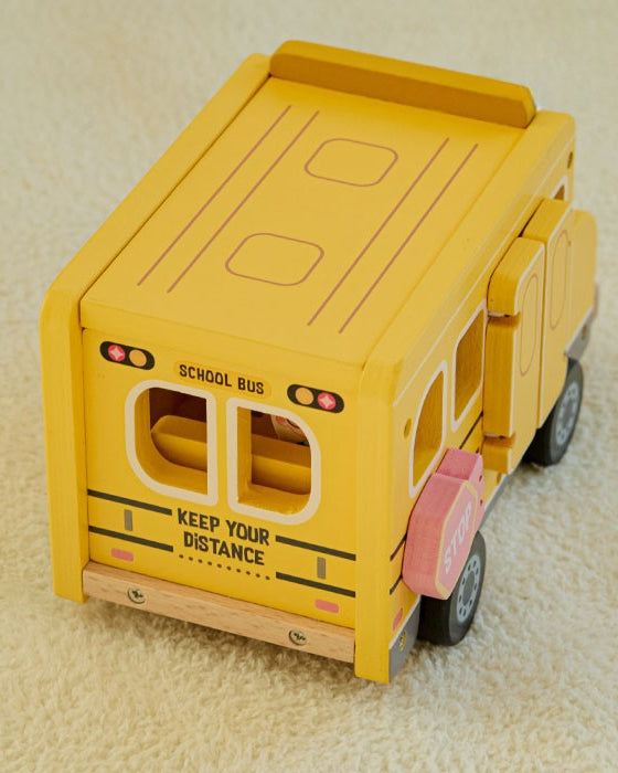 Four-step play sequence showing bus driving, roof opening, chalkboard flipping, and classroom pretend play scene