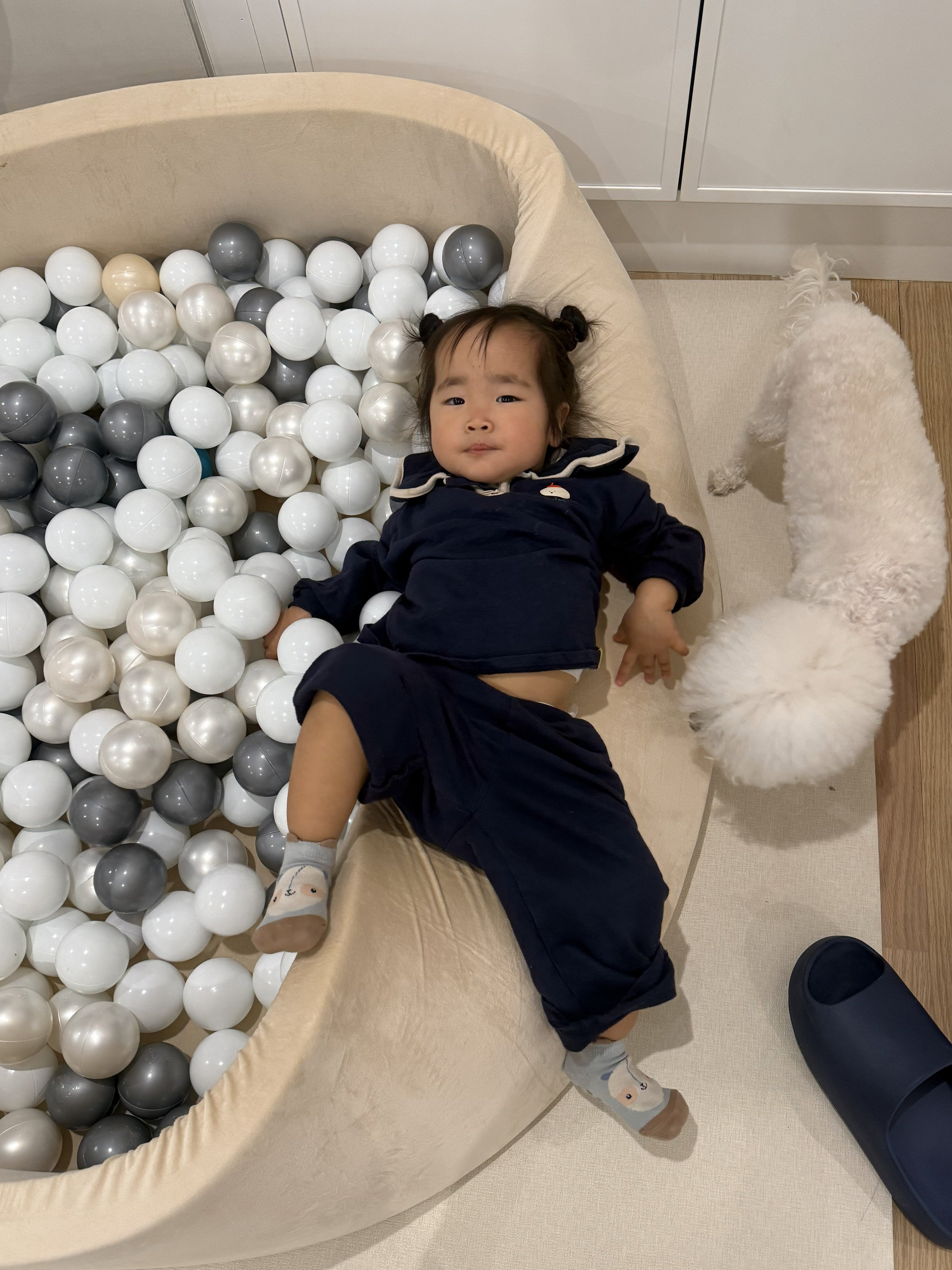 Child lying on the ball pit