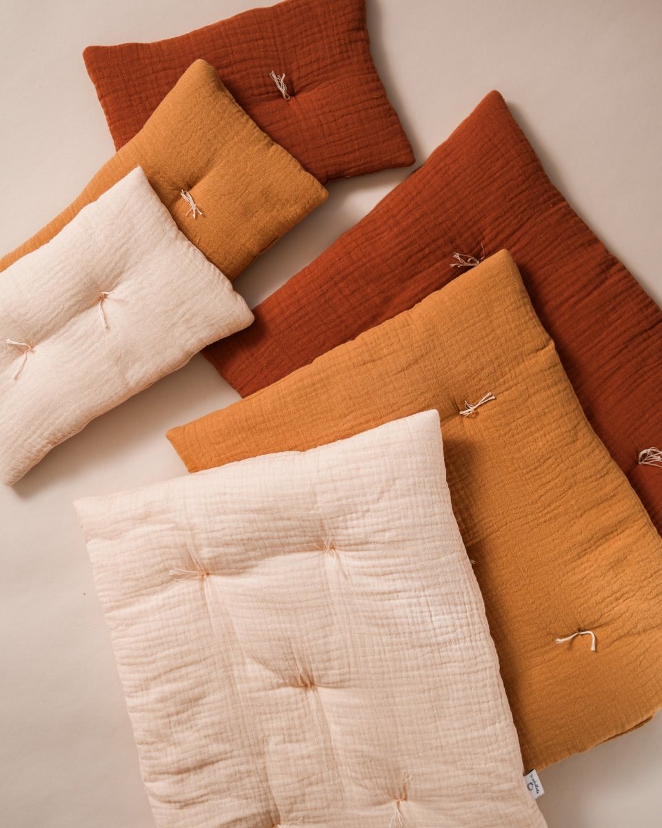 Playroom-ready doll pillow and coordinating blanket in pastel shades