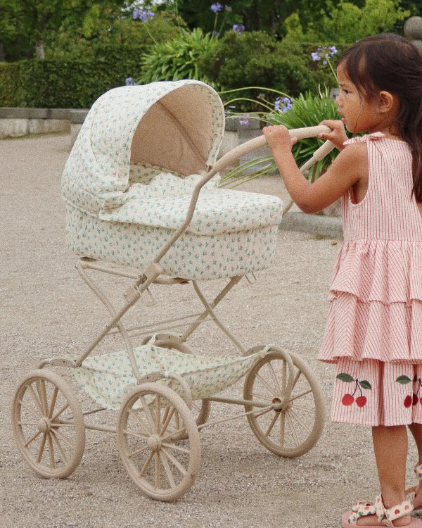 Vintage-style floral pram with romantic scallop edges and soft-grip handles perfect for sophisticated doll adventures