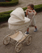 Multi star vintage doll pram with cream quilted fabric and scattered colorful stars on four large wheels