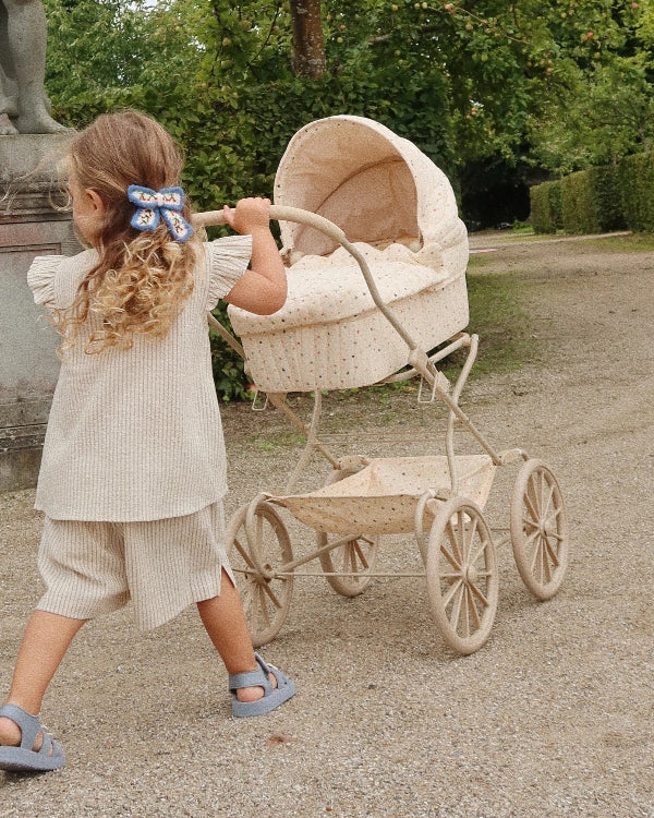 Premium doll stroller featuring multi-colored star pattern with organic cotton mattress and metal frame
