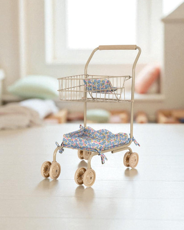 Professional-grade front wheels on kids shopping cart designed for easy steering and smooth movement across playroom floors