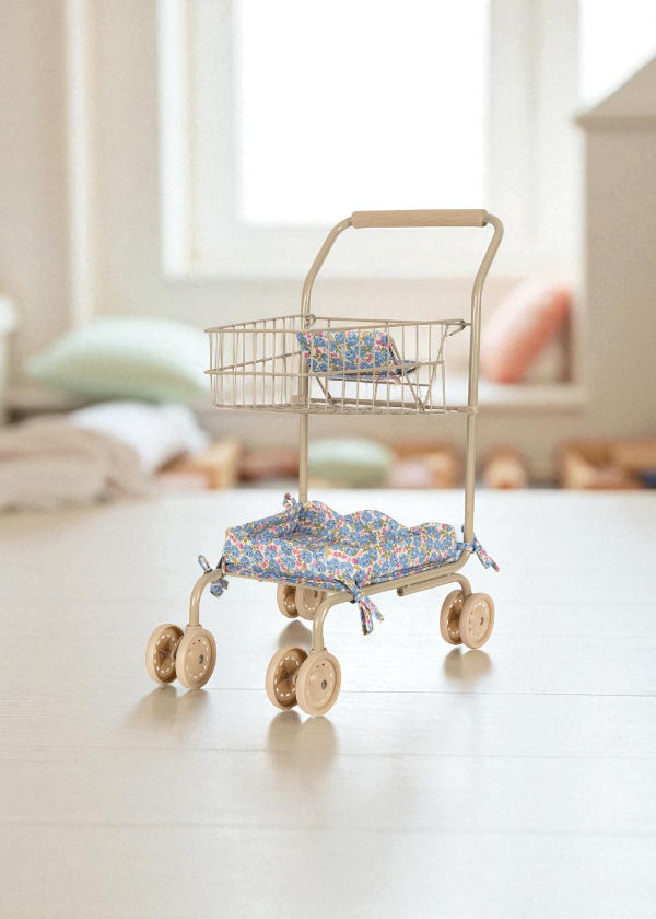 Professional-grade front wheels on kids shopping cart designed for easy steering and smooth movement across playroom floors