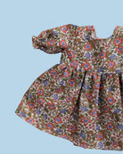 Doll clothing with miniature embroidered flowers