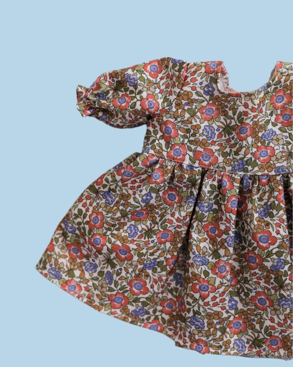 Doll clothing with miniature embroidered flowers