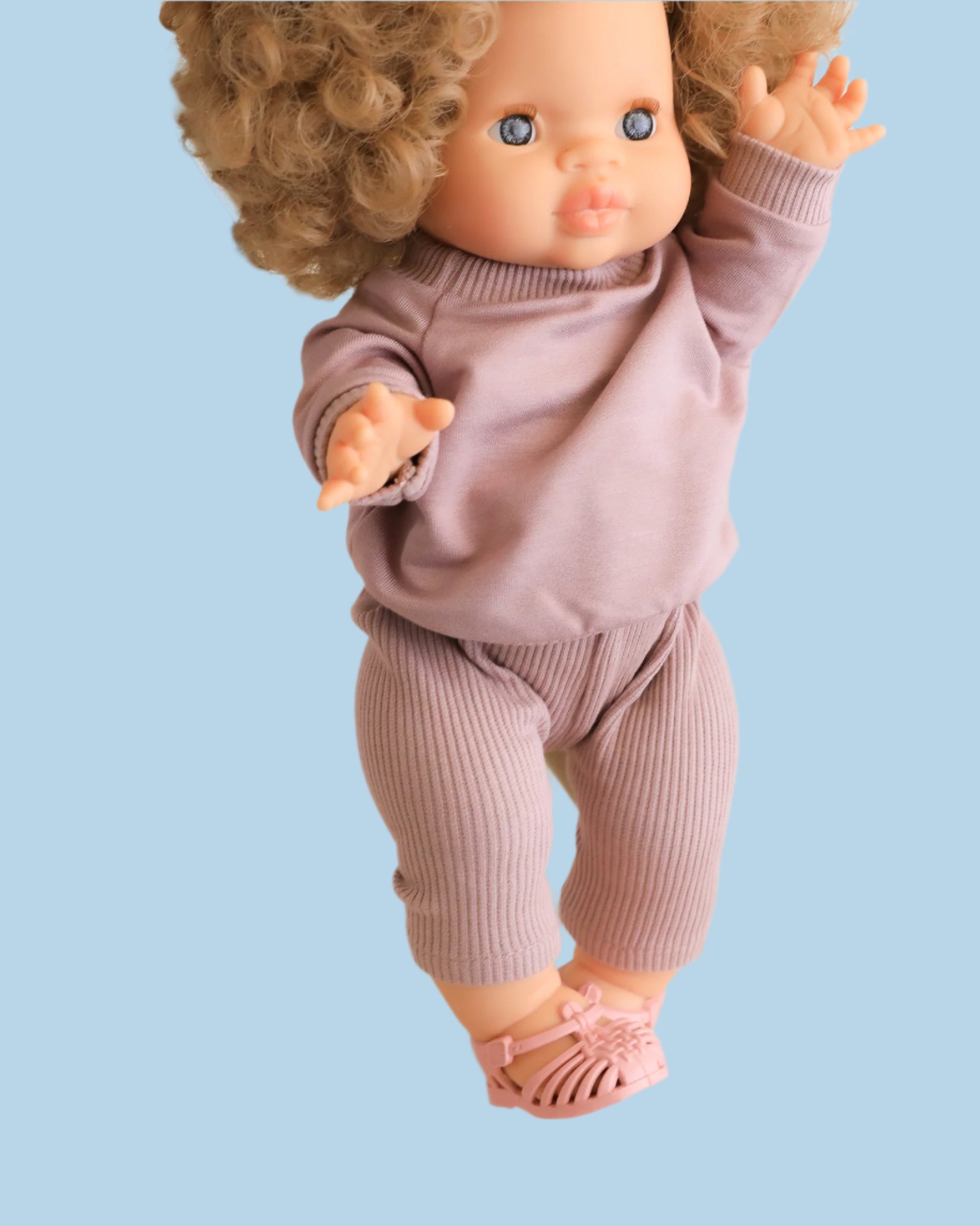 Lace-trimmed doll fashion with delicate details