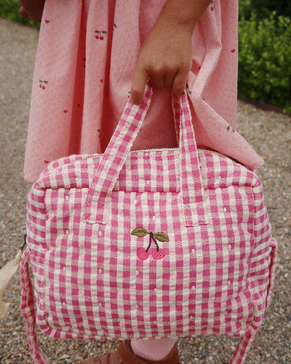 Bubblegum check pattern doll bag with coordinated hardware perfect for nurturing play