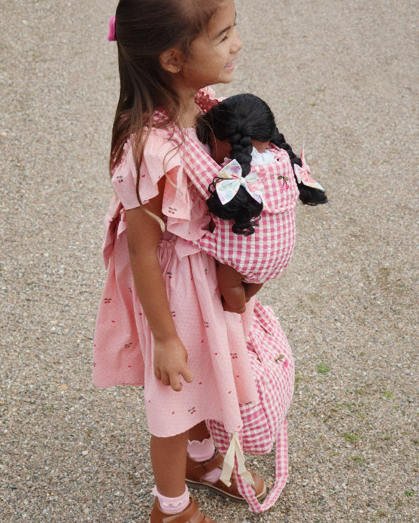 Pink checkered doll carrier with machine washable fabric ideal for daily adventures