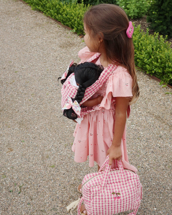 Sweet gingham baby doll carrier with adjustable straps perfect for hands-free nurturing play