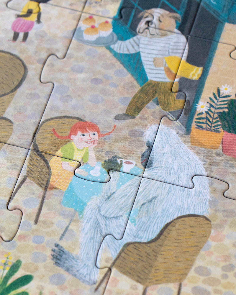 Jigsaw puzzle with cartoon characters and furniture on a wooden surface