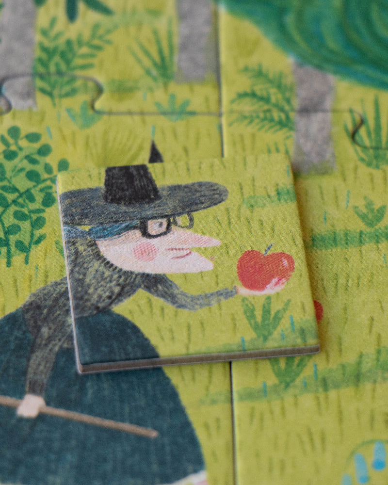 Wooden puzzle piece with a witch holding an apple in a forest setting