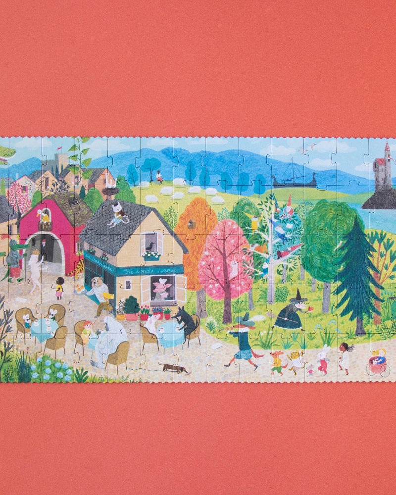 Colorful puzzle with a scenic village design on a red background