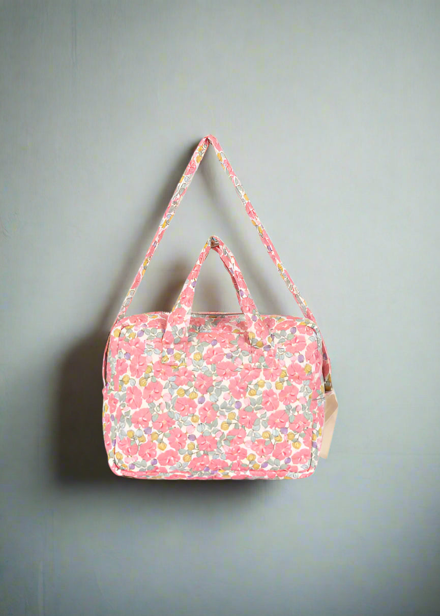 Rose anglaise baby doll diaper bag with romantic floral pattern and dual carrying handles