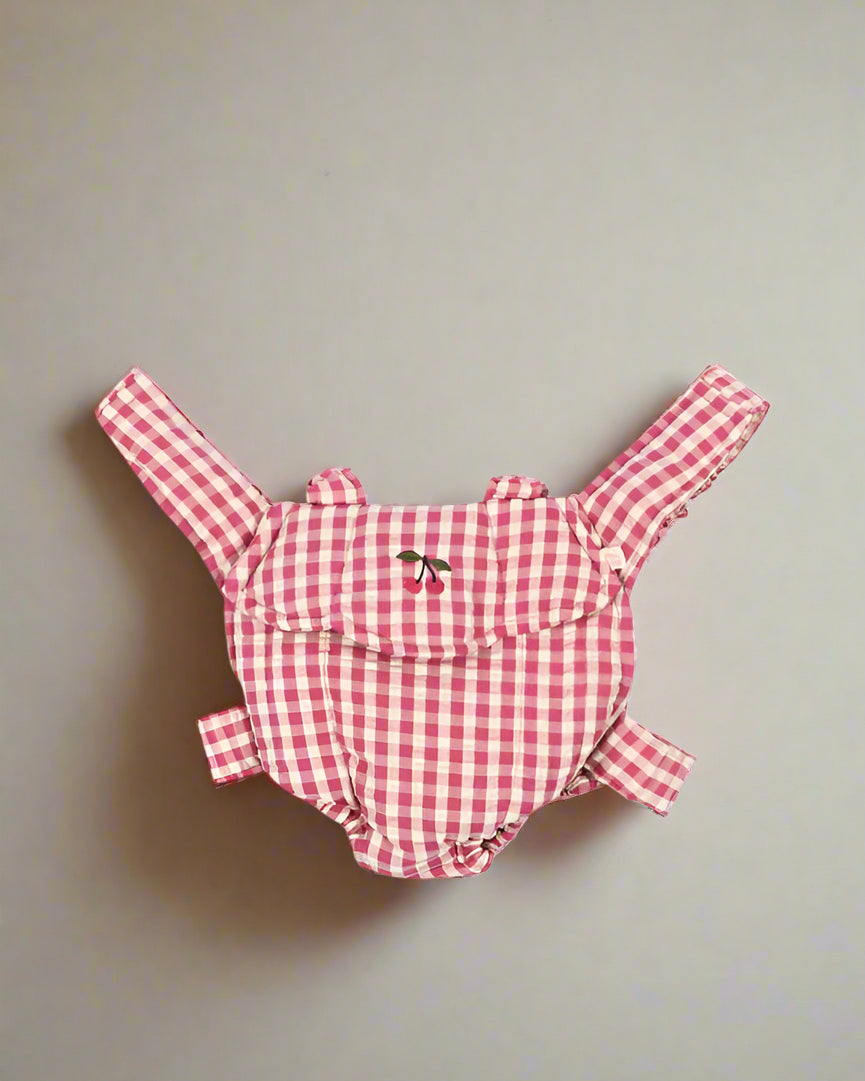 Bubblegum check doll carrier with pink gingham pattern and comfortable scrunch straps