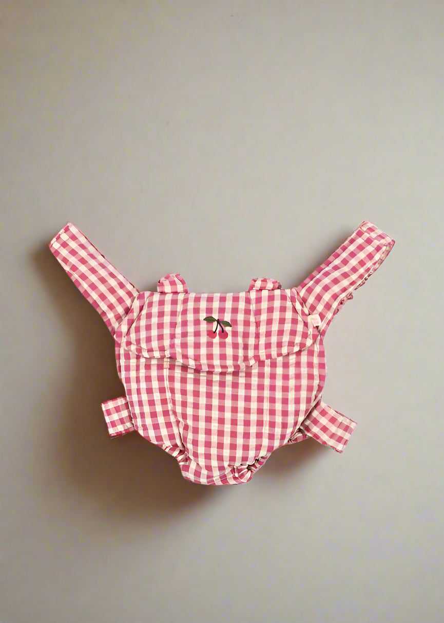 Bubblegum check doll carrier with pink gingham pattern and comfortable scrunch straps