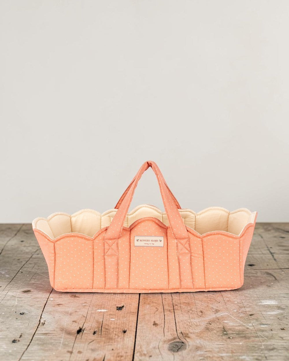 Playroom Collective Konges Sloejd quilted coral doll bassinet with white dots and scalloped cream lining