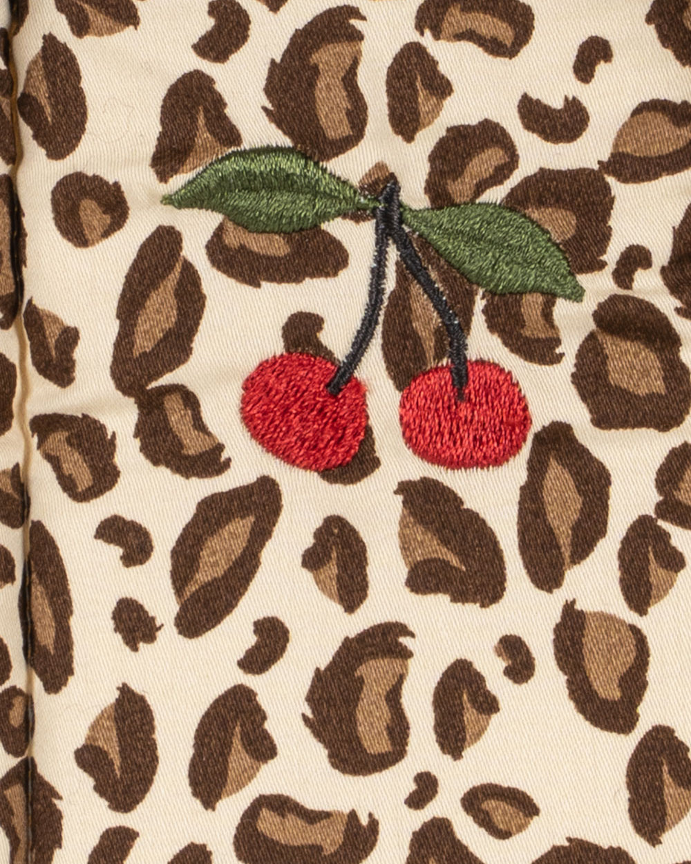 Leopard print fabric with embroidered cherries on a beige background