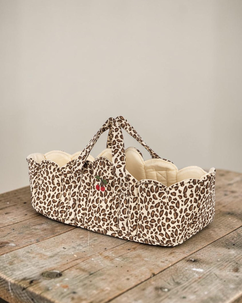 Playroom Collective Konges Sloejd leopard print doll bassinet with scalloped cream lining and embroidered cherry detail