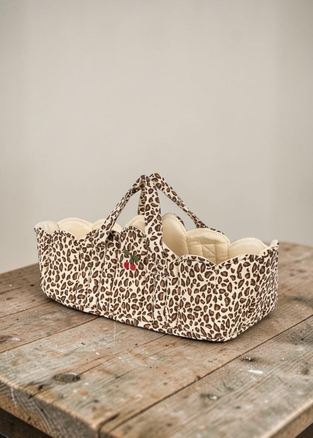 Playroom Collective Konges Sloejd leopard print doll bassinet with scalloped cream lining and embroidered cherry detail