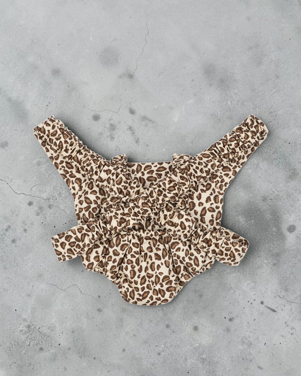 Playroom Collective Konges Sloejd doll carrier in cream and brown leopard print with elastic straps and cherry detail