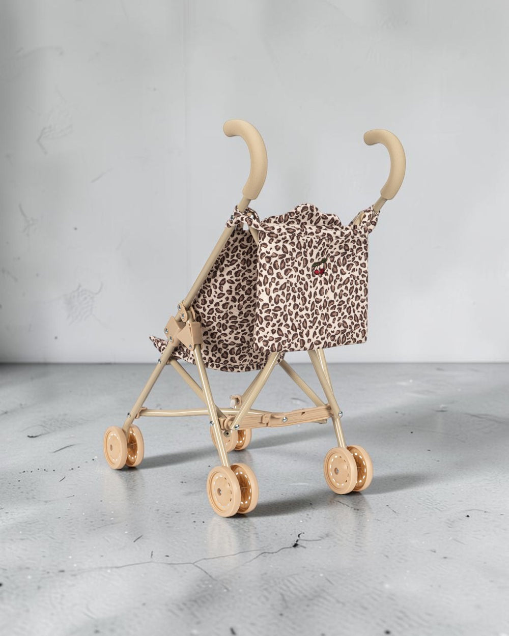 Playroom Collective Konges Sloejd doll stroller in leopard print with sage frame and cherry detail