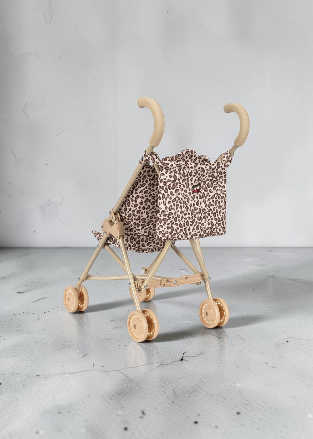 Playroom Collective Konges Sloejd doll stroller in leopard print with sage frame and cherry detail