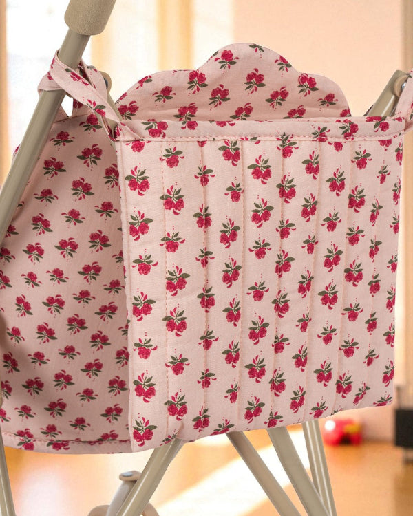 Close-up of Rosie Rose print stroller hood showing delicate pink roses with green leaves pattern and premium cotton construction