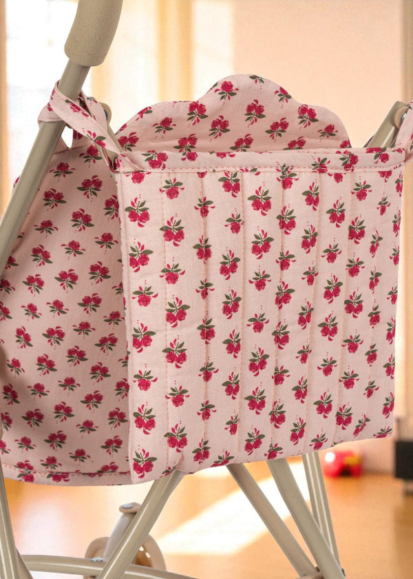 Close-up of Rosie Rose print stroller hood showing delicate pink roses with green leaves pattern and premium cotton construction