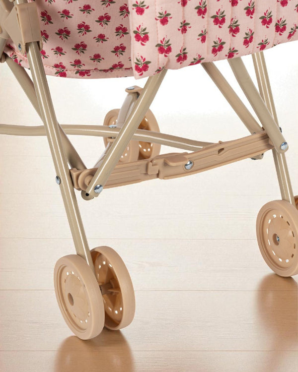 Rose print stroller styled with matching Rosie Rose collection pieces in vintage-inspired outdoor play setting
