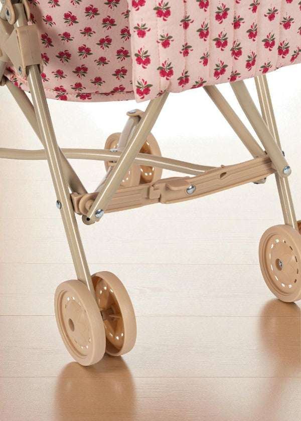 Rose print stroller styled with matching Rosie Rose collection pieces in vintage-inspired outdoor play setting