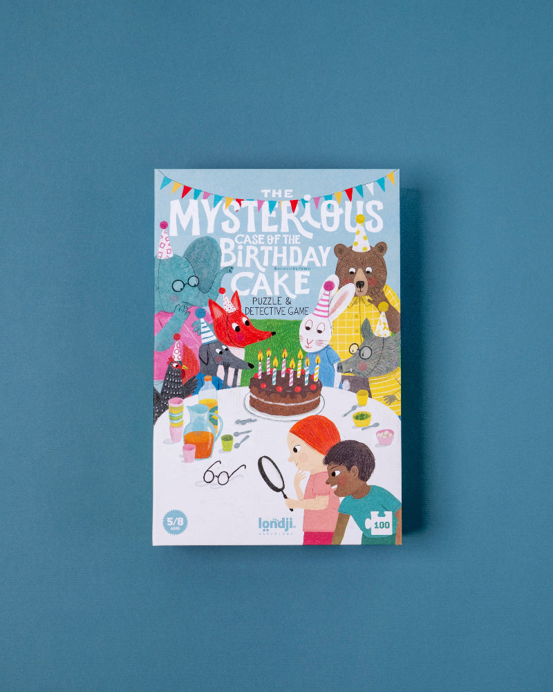 Puzzlecover of 'The Mysterious Case of the Birthday Cake' on a blue background