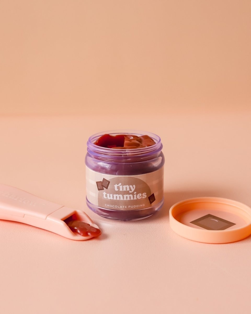 Miniature play kitchen accessories including Tiny Harlow chocolate pudding doll food set