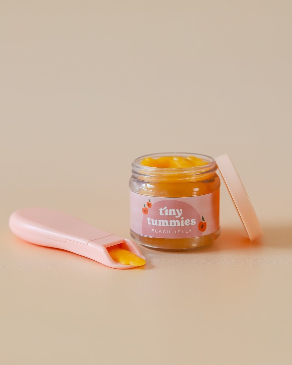 Diverse play kitchen food collection featuring Tiny Harlow peach food jar