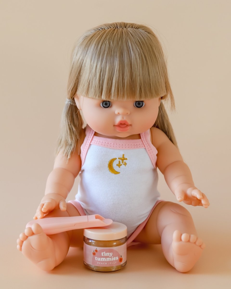 Collectible play kitchen food featuring Tiny Harlow peach jelly doll bottle with spoon