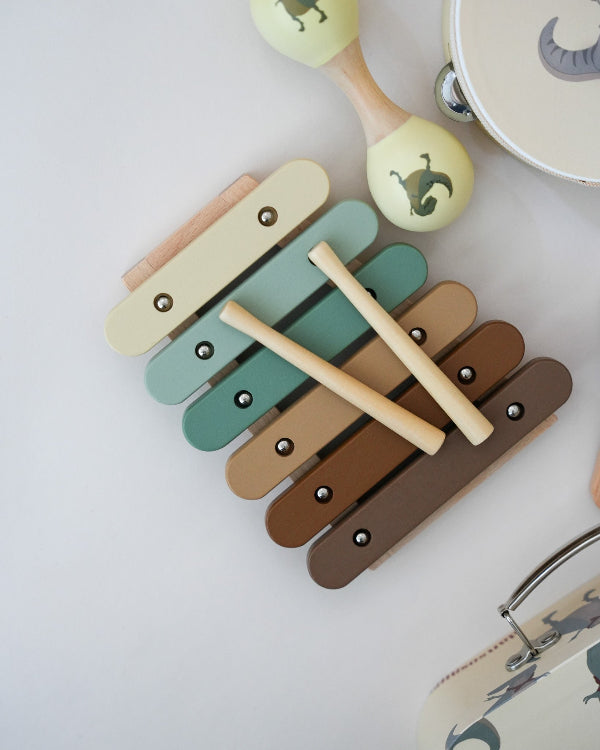 Complete wooden music play set with dinosaur motifs and natural wood finish perfect for children