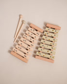 Montessori wooden xylophone with 7 tuned aluminum bars arranged in correct musical sequence