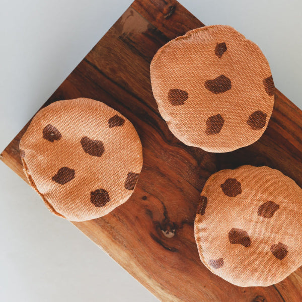 Three handcrafted Danish chocolate chip cookie play food pieces with silk screen printing on wooden board