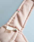 Miniature baby doll carrier promoting nurturing pretend play scenarios