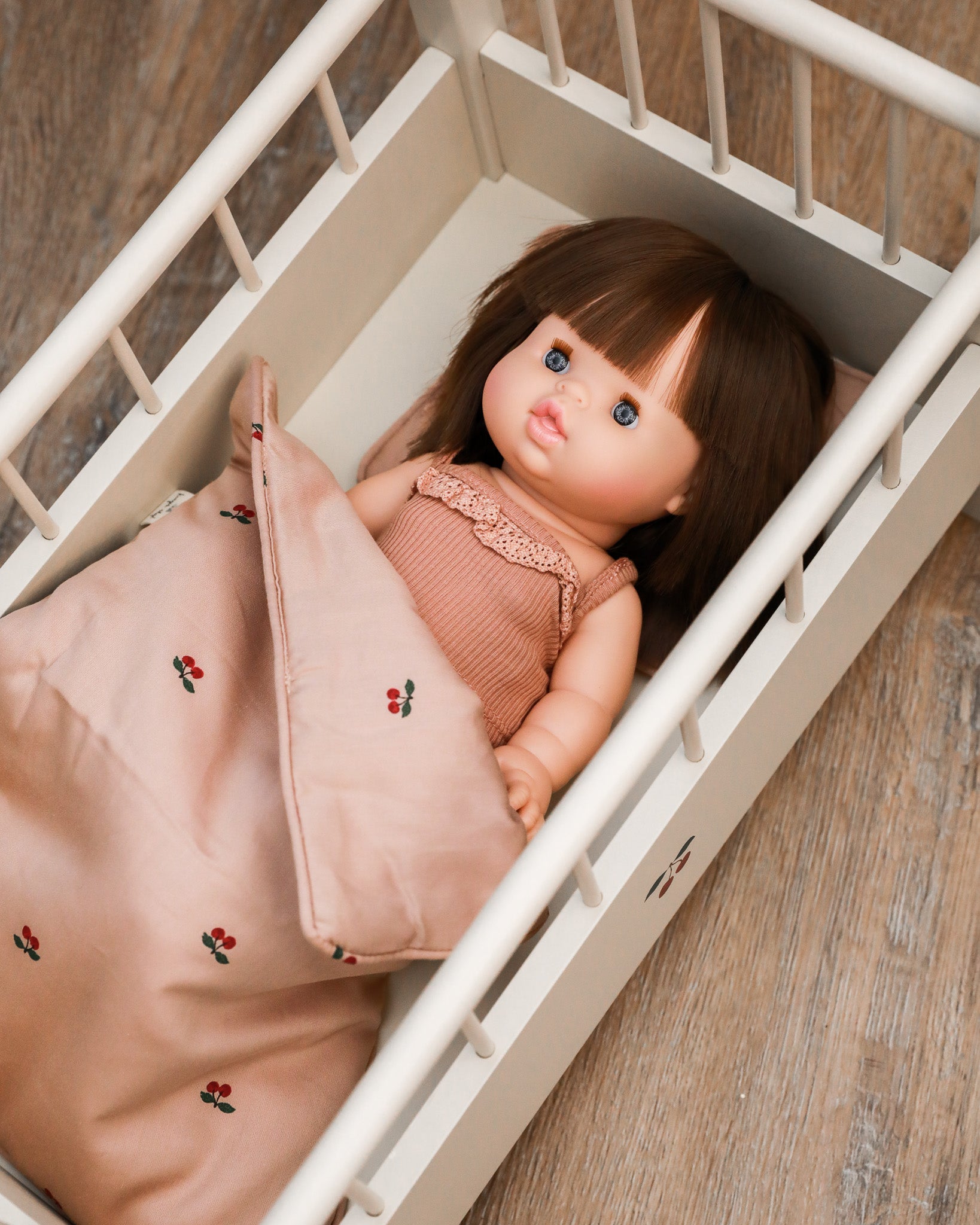 Playroom-quality miniature bedding set with detailed doll pillow and blanket